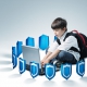 Image of a young boy sitting on the floor with his backpack on and typing on a laptop while being surrounded with small blue / silver shields.